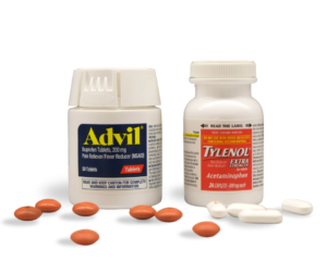 ibuprofen vs acetaminophen - You Drug Mart Two medicine bottles labeled Advil and Tylenol sit on a white background with orange and white pills scattered around them (pain relievers).
